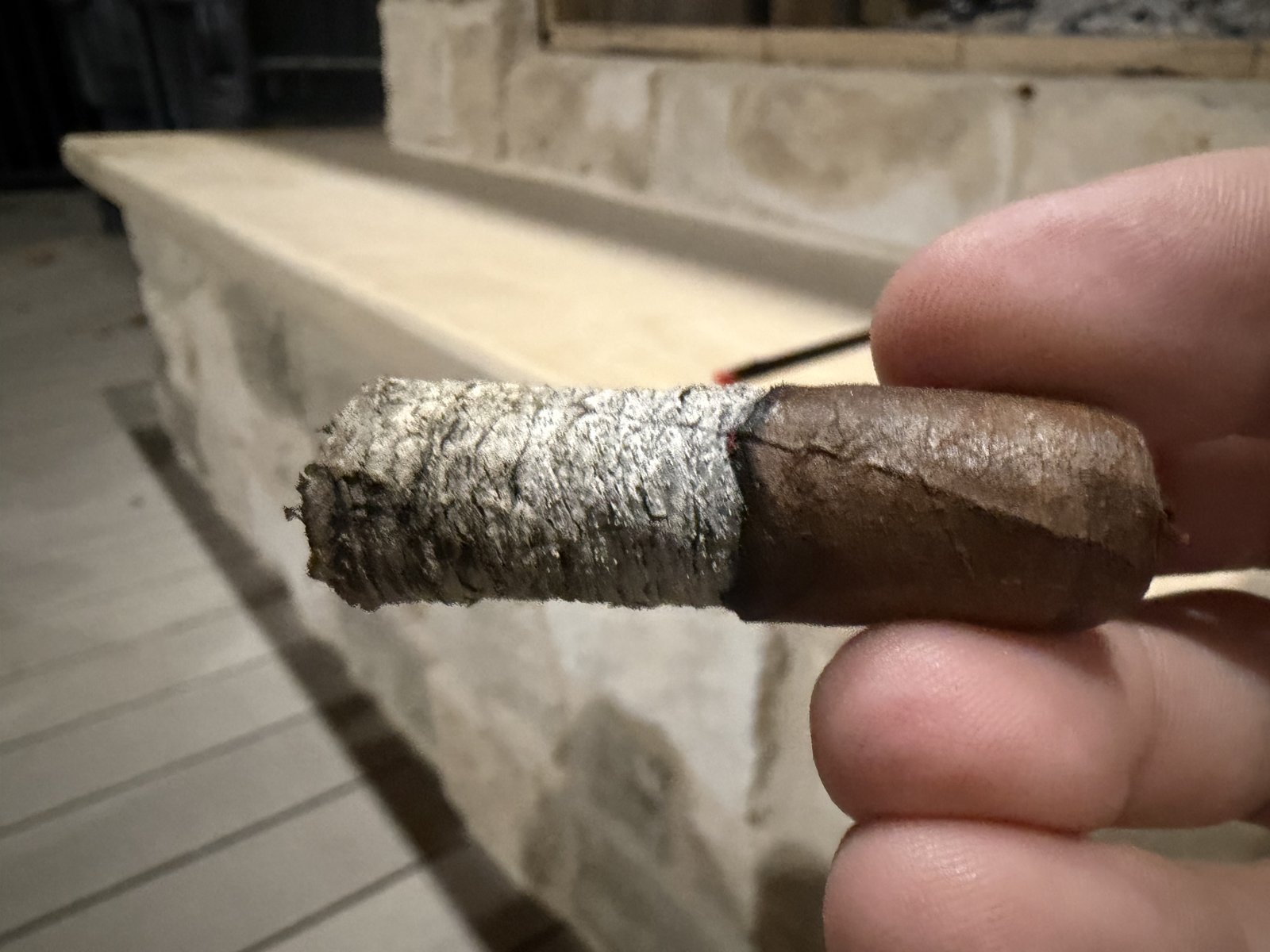 Arturo Fuente Hemingway Short Story in the second half with a tight, well-stacked gray ash, band removed