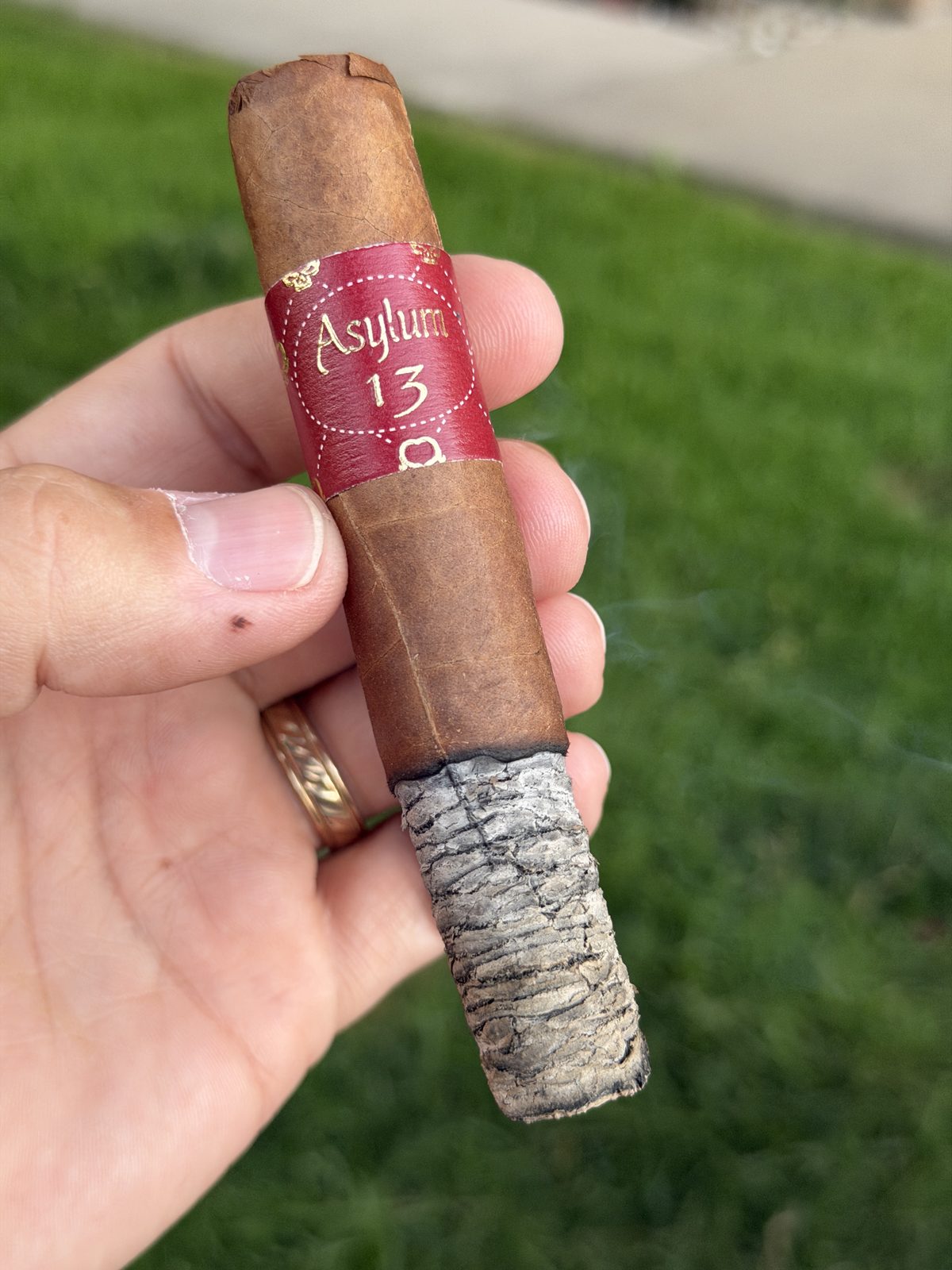 The Asylum 13 Corojo lit with a long, tight, dime-stacked grey ash held horizontally