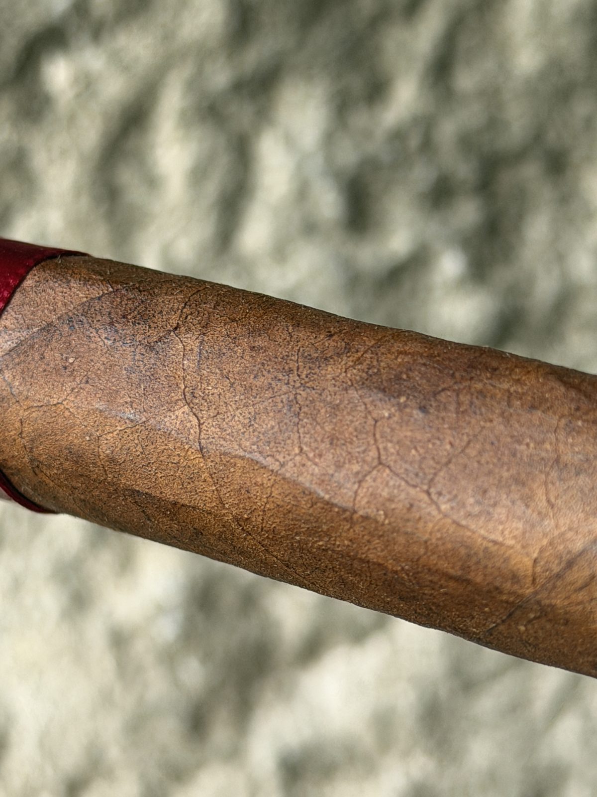Close-up of the box-pressed My Father Flor de las Antillas wrapper showing light tooth, veins, and the pressed edge