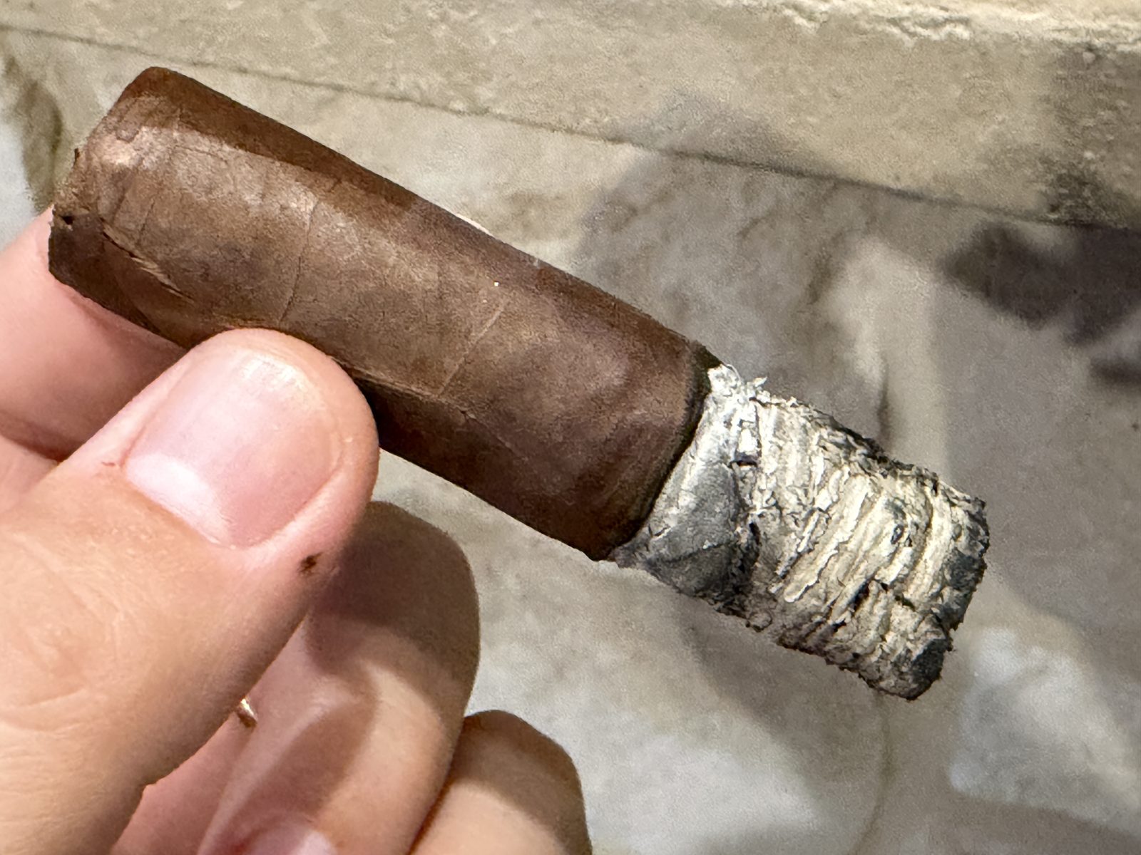 Final third of the Oliva Serie V Toro with a thick stack of gray ash and a slightly uneven burn line