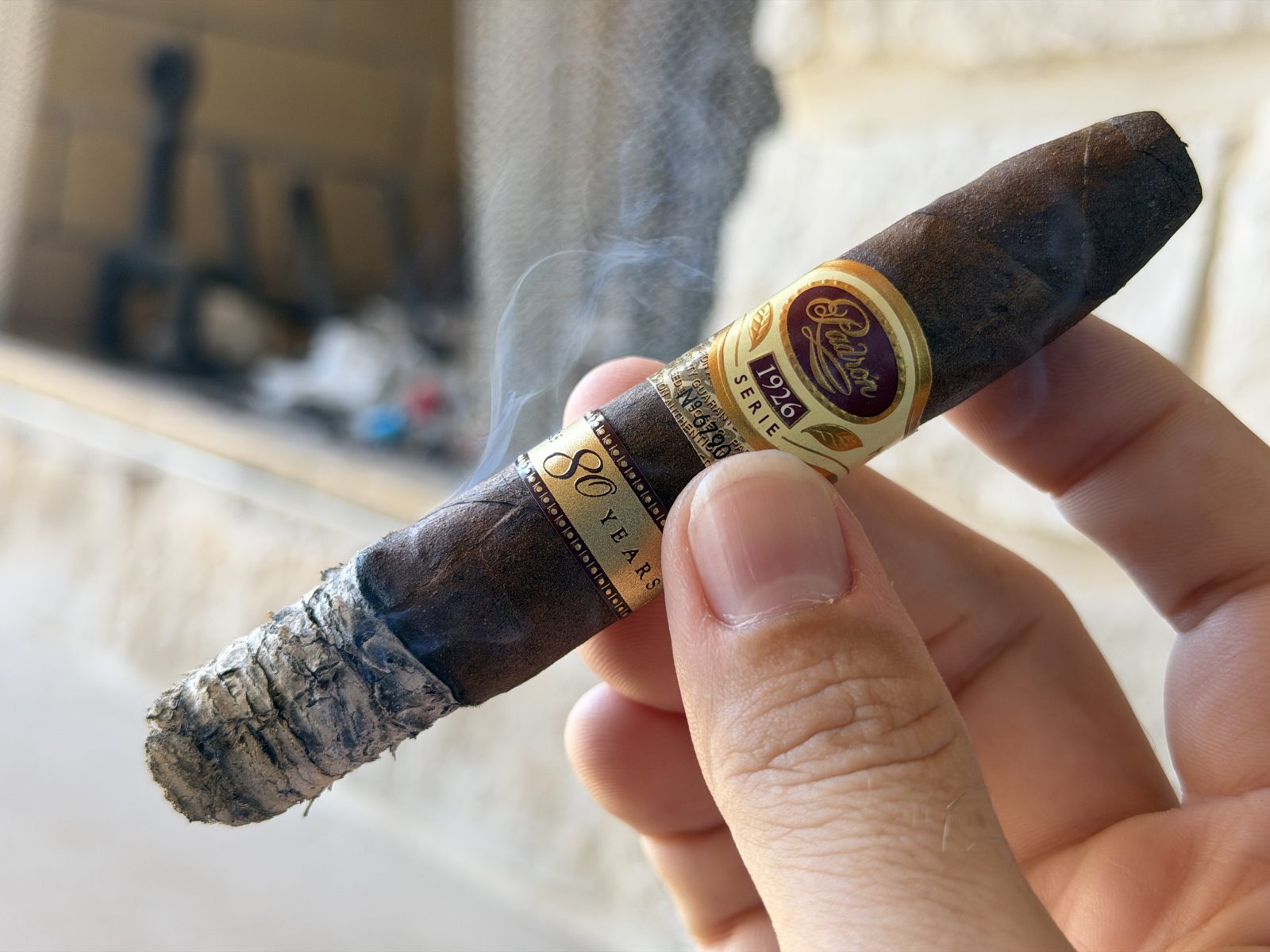 Padrón 1926 Serie 80 Years Maduro in the first third with the first ash forming just past the perfecto tip