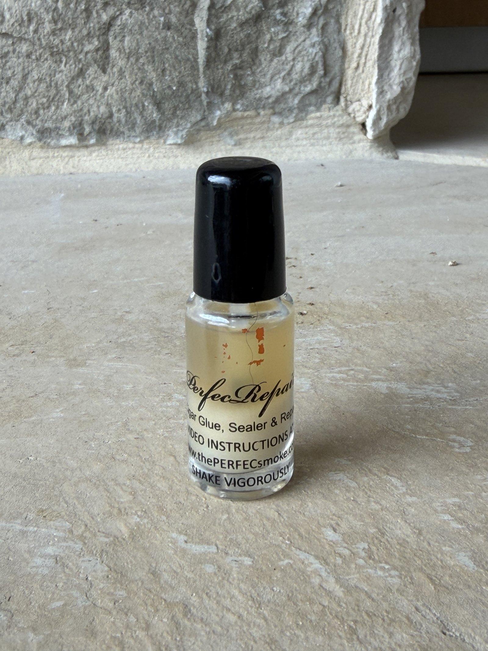 Close-up of the PerfecRepair label reading food grade, cigar glue sealer and repair, shake vigorously
