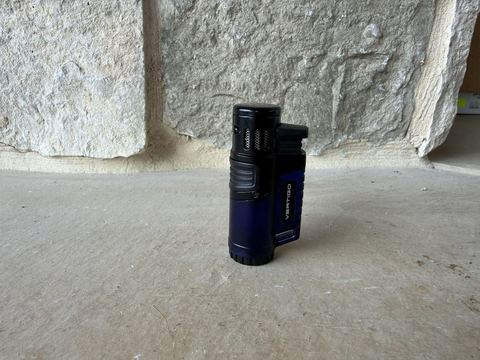 Vertigo Hawk triple jet flame lighter standing upright, black and blue body with the cap closed and VERTIGO branding on the side